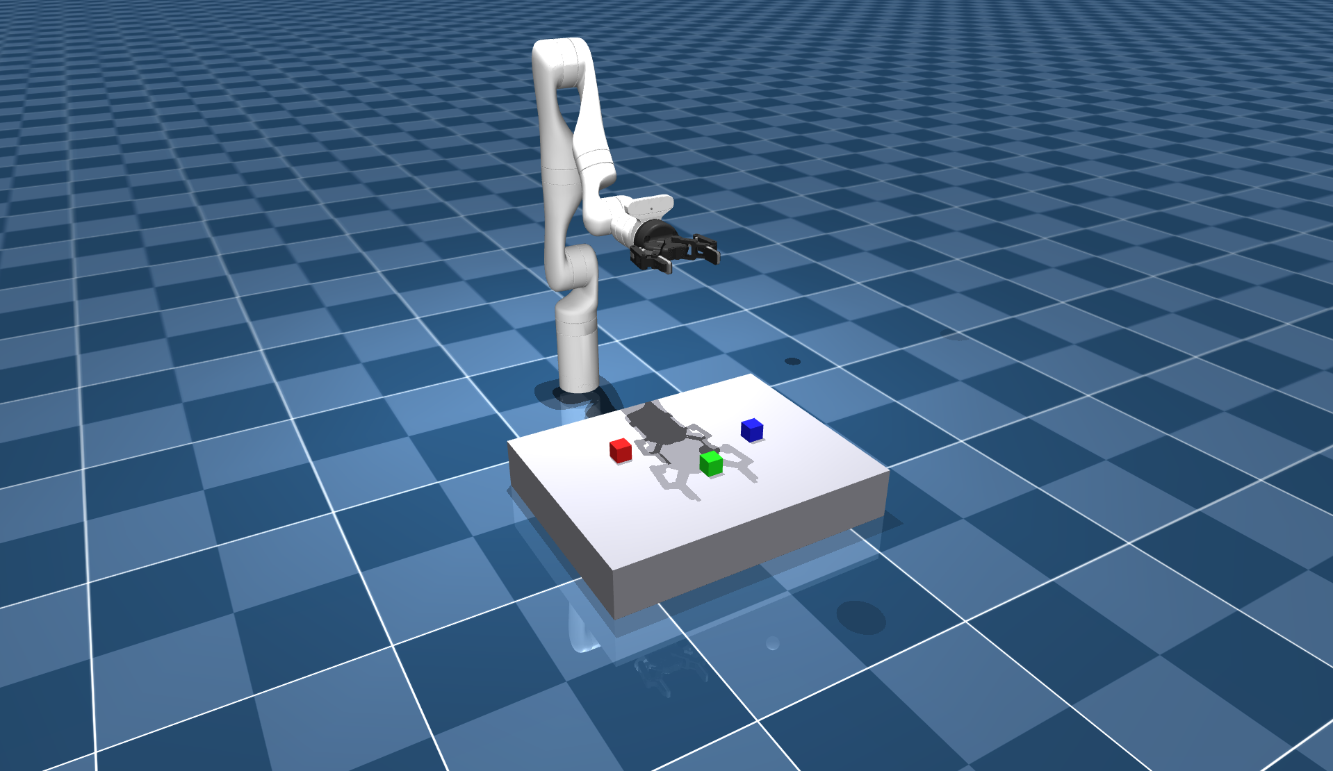The vla_sim scene, with a Kinova Gen3 arm over a table holding a red, a green, and a blue cube